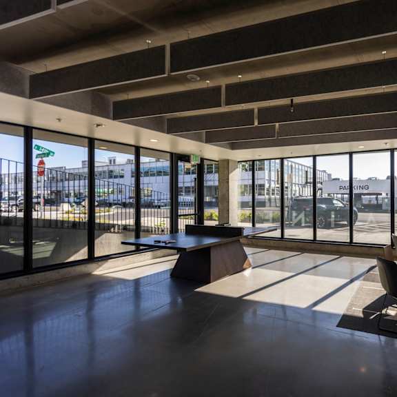 the lobby of a building with large windows and a table and chairs at moraine, tacoma, washington
