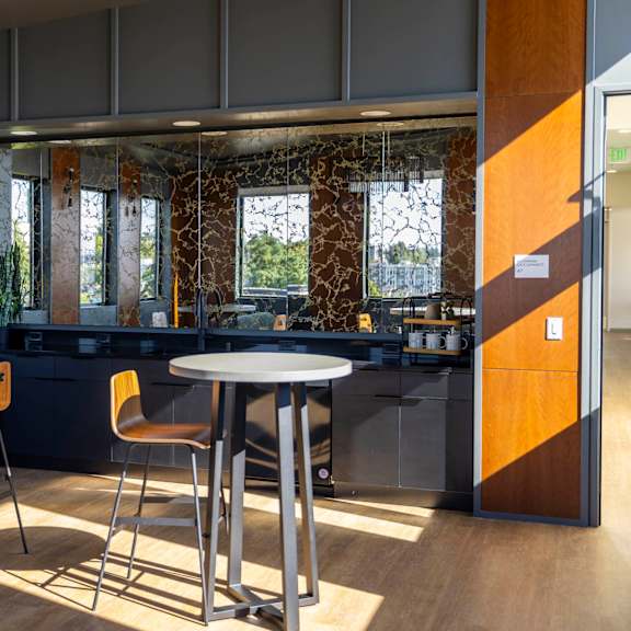 a dining area with tables and chairs in a lobby at moraine, tacoma, wa 98402