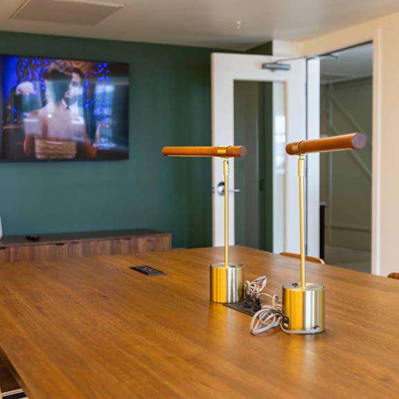 a dining room with a wooden table and a tv on the wall at moraine, tacoma, wa