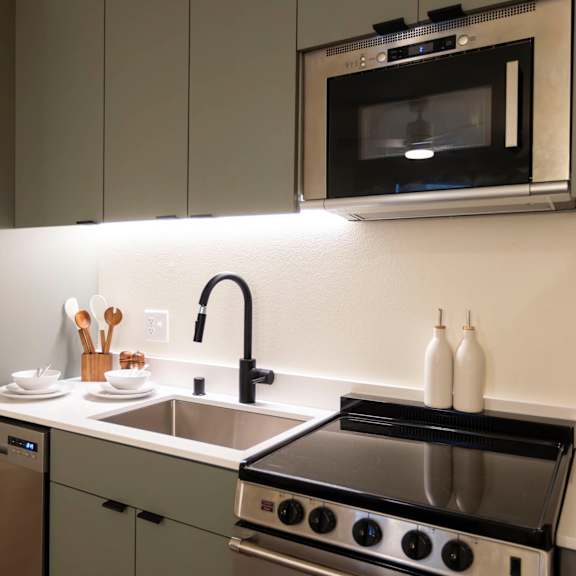 a kitchen with a sink and a stove and a microwave at moraine, tacoma, washington 98402
