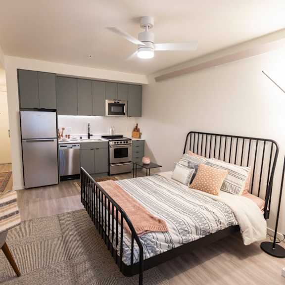 a bedroom with a bed and a kitchen at moraine, tacoma, washington 98402