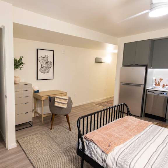 a washer and dryer in a living room with a desk and a kitchen at moraine, washington 98402