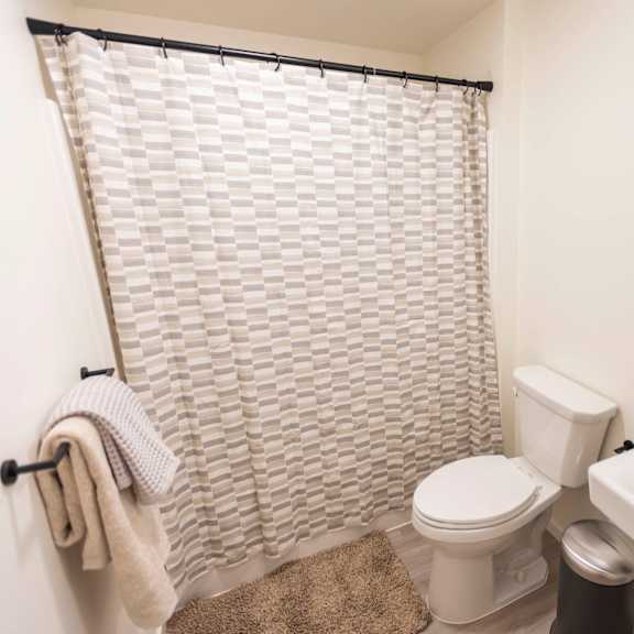 a bathroom with a shower toilet and sink at moraine, tacoma