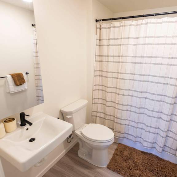 a bathroom with a white toilet and a white sink at moraine, tacoma, washington 98402