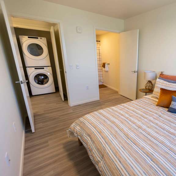 a bedroom with a bed and a washing machine at moraine, tacoma, washington