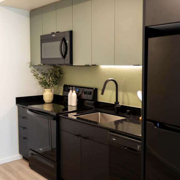 a kitchen with a sink and a refrigerator at moraine, tacoma, washington 98402