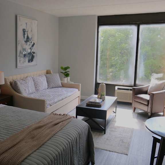 a bedroom with two beds and a couch and a table at schaefer ridge apartments, branson
