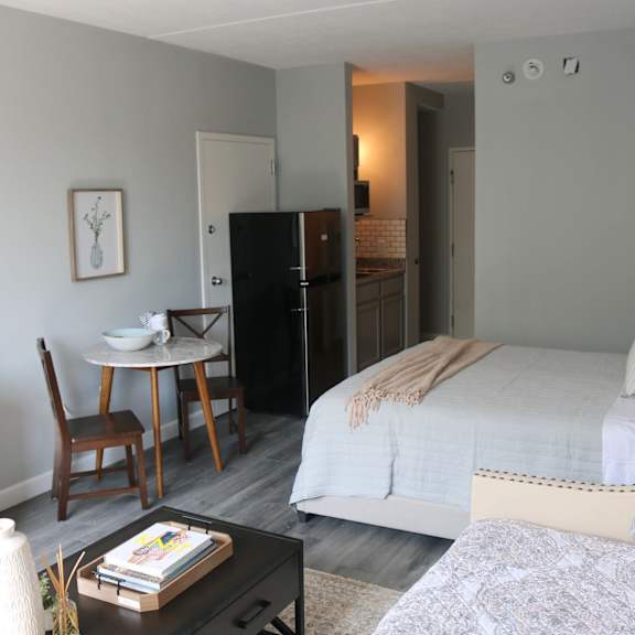 a bedroom with a bed and a couch and a table at schaefer ridge apartments, branson , mo