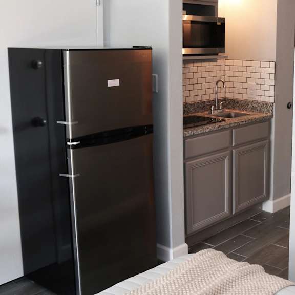 a small kitchen with a refrigerator and a sink at schaefer ridge apartments, missouri