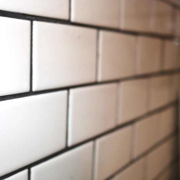 a close up of a white tiled wall with white subway tiles at schaefer ridge apartments, branson , mo 65616