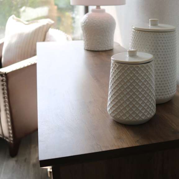 a wooden table with jars and vases on it at schaefer ridge apartments, missouri