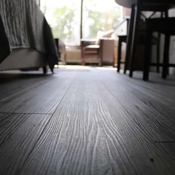 a living room with wooden floors and a window at schaefer ridge apartments, branson , mo
