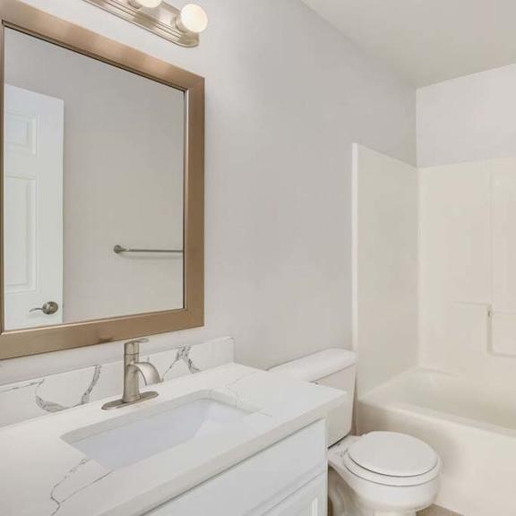 a bathroom with a sink toilet and bathtub