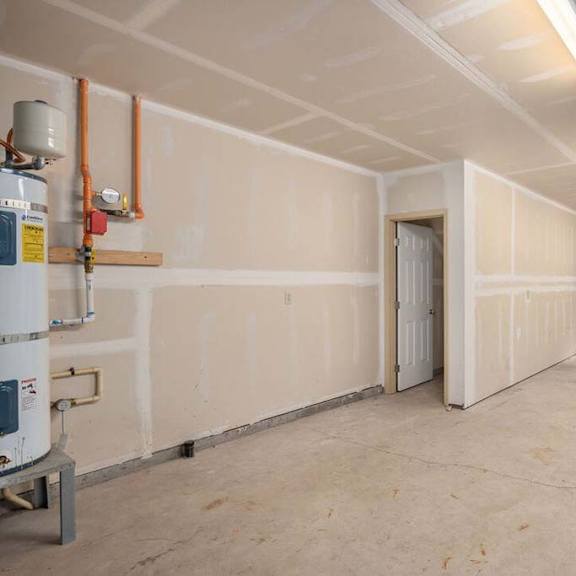 a large room with white walls and a door