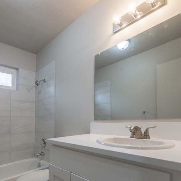 a bathroom with a sink toilet and bathtub