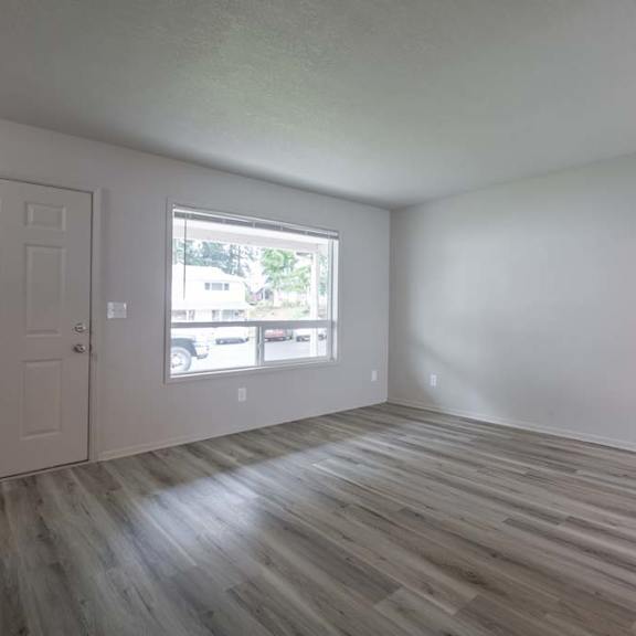 an empty room with a door and a window