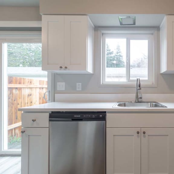 a kitchen with a sink and a window
