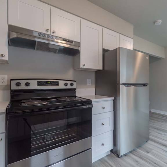 a kitchen with a stove and a refrigerator