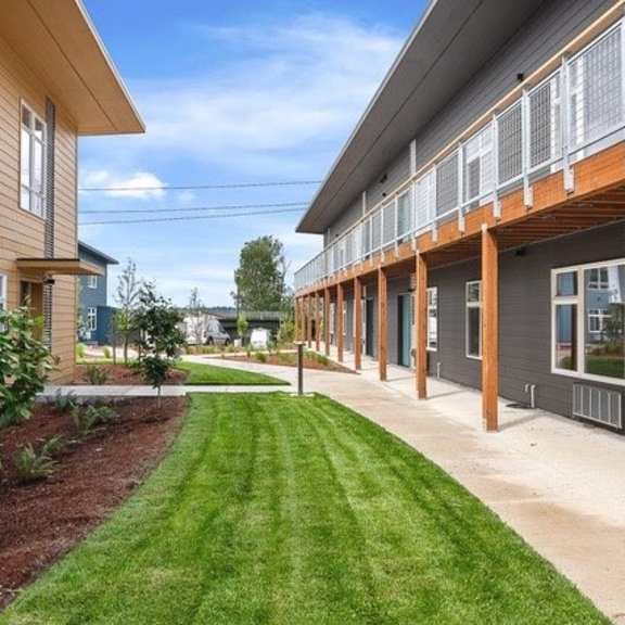 a grassy area in front of a building