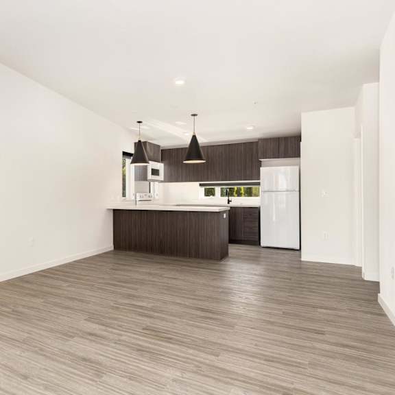 the living room and kitchen in a 555 waverly unit