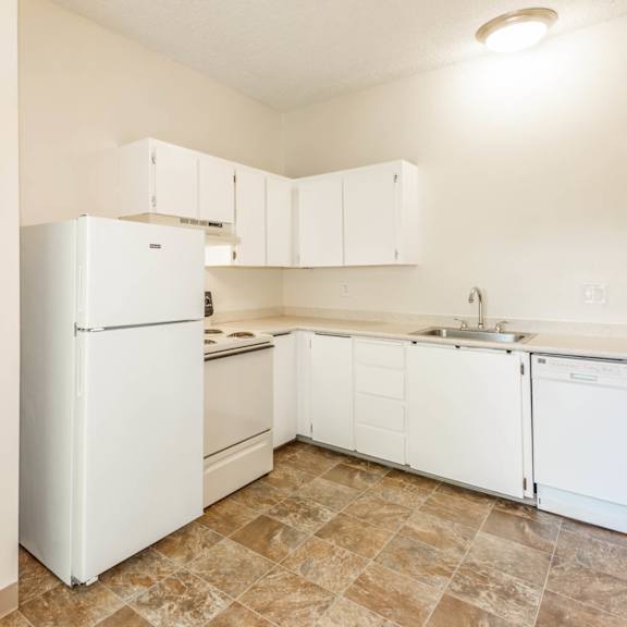 a kitchen with white appliances and cabinets.