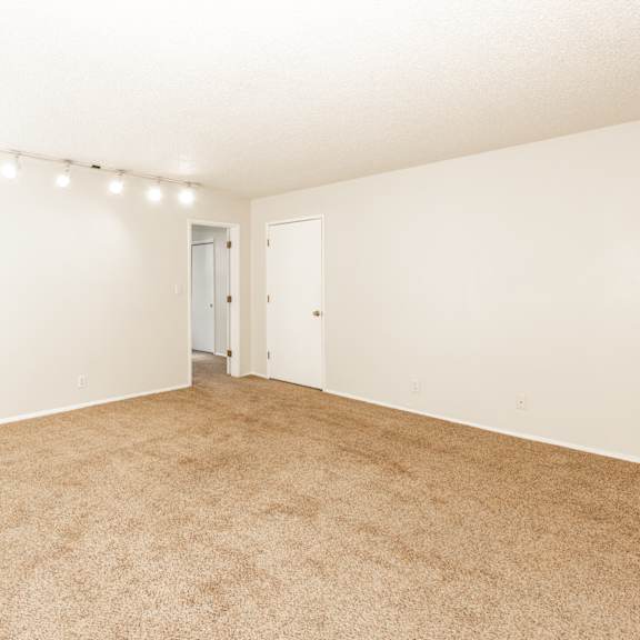 a room with carpeted floor and white walls.