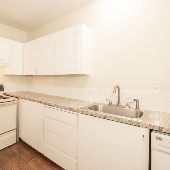a kitchen with white appliances and cabinets.