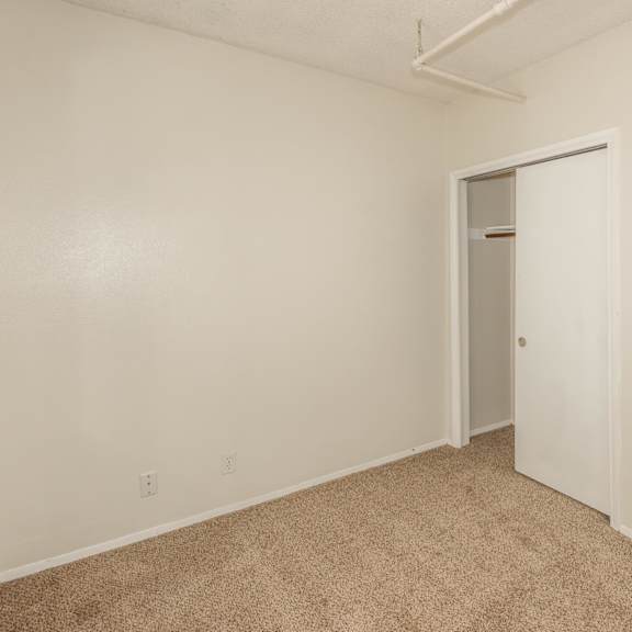 a room with a carpeted floor and a white door.
