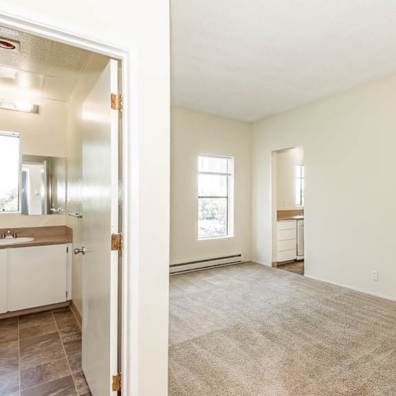 a room with a carpeted floor and a door on the right side.