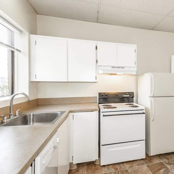 a kitchen with white appliances and cabinets.