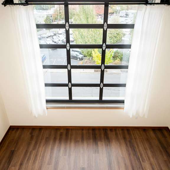a window overlooking a parking lot at atomic orchard experiment, portland, 97232