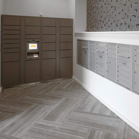 a row of mailboxes are lined up on a wall.