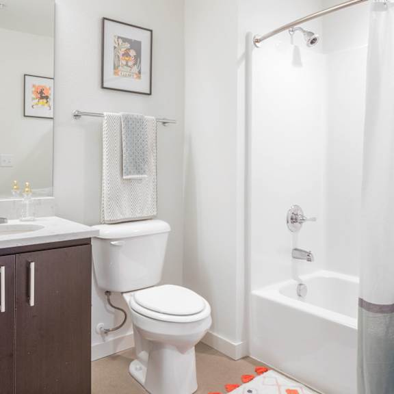 a white toilet sits next to a sink in a bathroom.