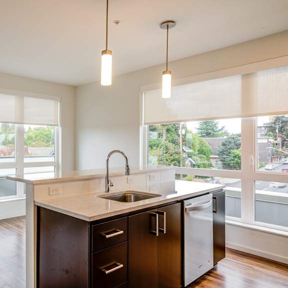 a kitchen with a sink and a refrigerator.