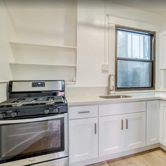 a modern kitchen with a stove, sink, and refrigerator at clay & tiffany, portland, 97201