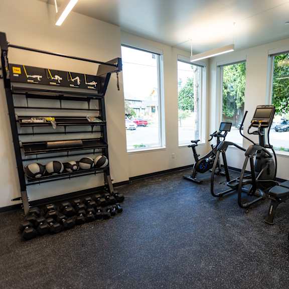 a gym with various exercise equipment in a room with windows at shift, oregon, 97217