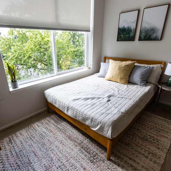 a bedroom with a bed and a large window at shift, oregon