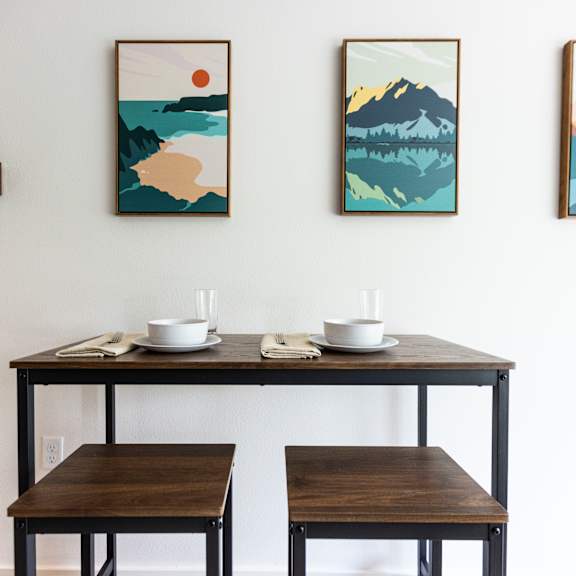 a dining room with three tables and three paintings on the wall at shift, portland oregon