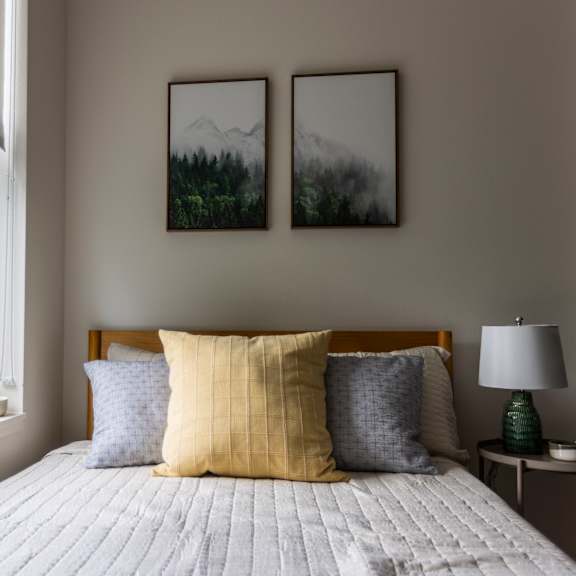 a bedroom with a bed and a large window at shift, portland, 97217