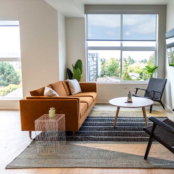 a living room with a couch and two chairs and a table at shift, portland, or 97217