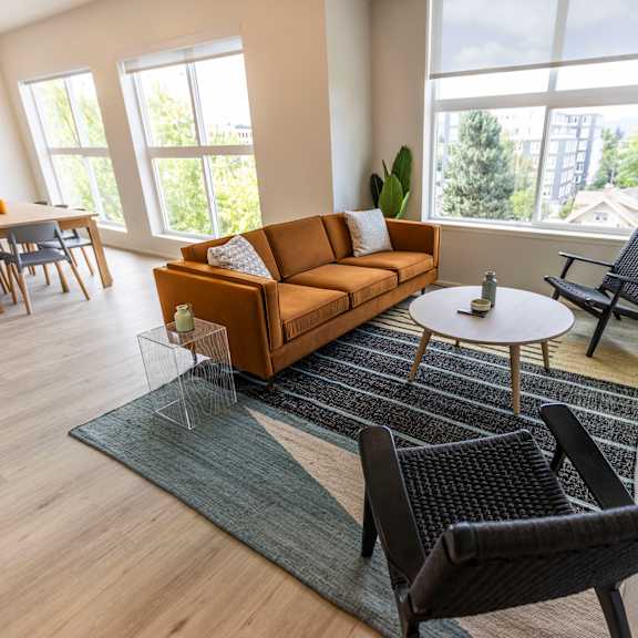 a living room with a couch and chairs and a table at shift, portland oregon
