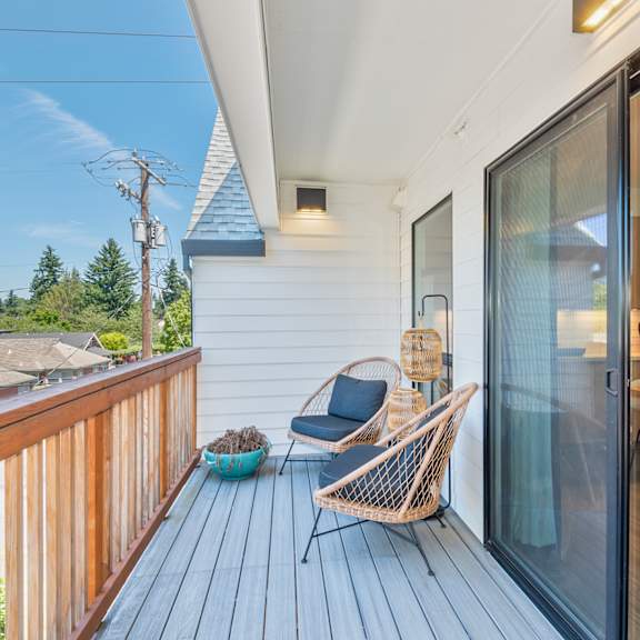a wooden deck with a chair and a table at society 62 apartments, portland