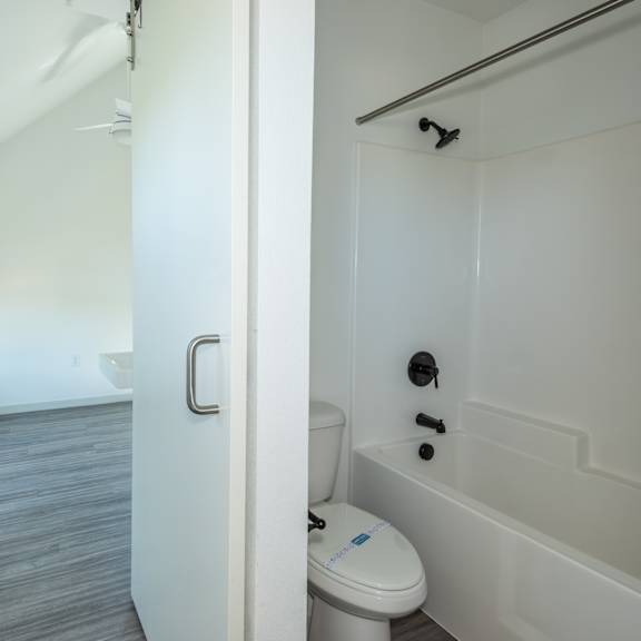 a white toilet with a blue sticker on it at society 62 apartments, portland, or, 97213