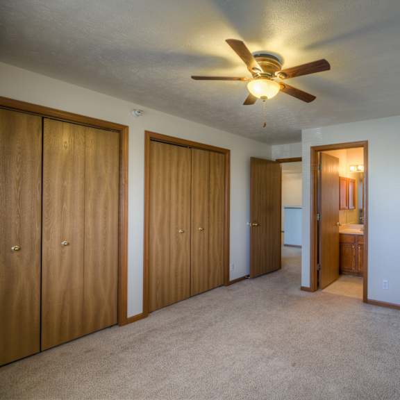 a room with a ceiling fan and a carpeted floor.