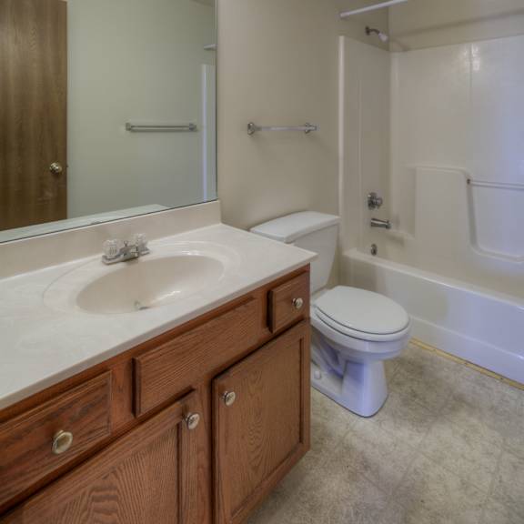 a bathroom with a sink, toilet, and bathtub.