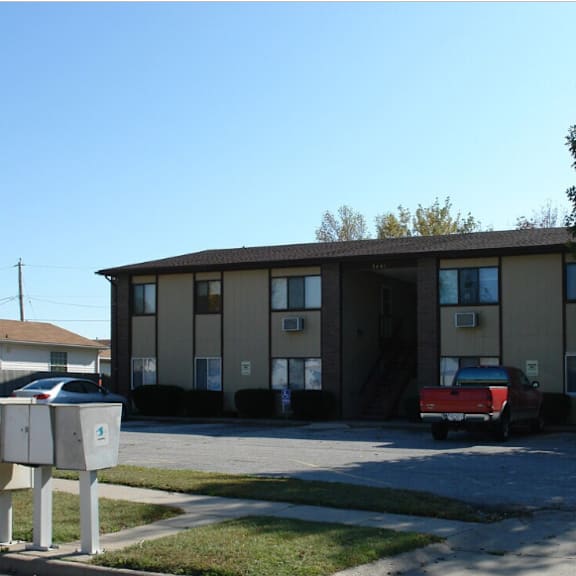 a red car is parked in front of a building.