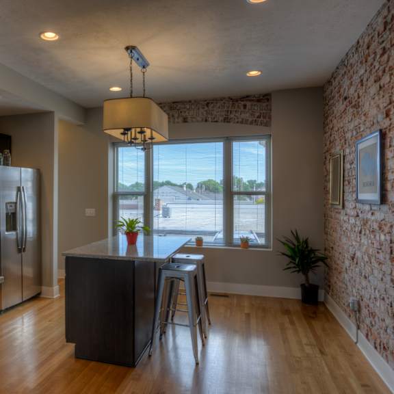 a kitchen with a refrigerator, microwave, and oven.