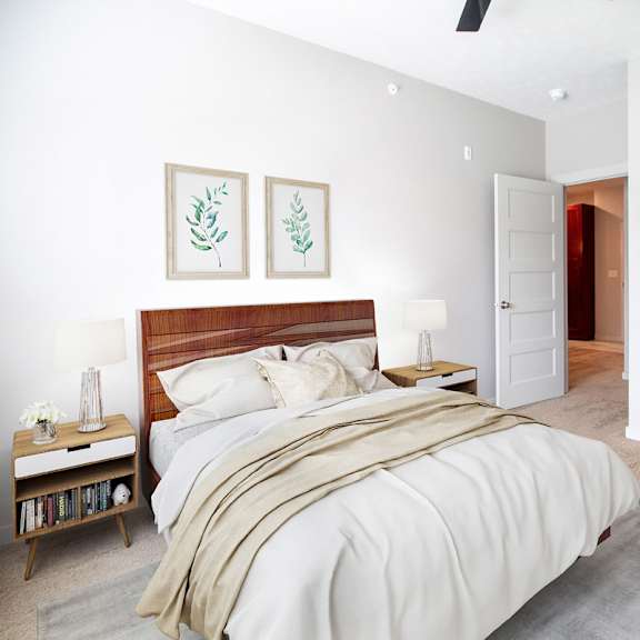 a bedroom with a large bed and a ceiling fan.