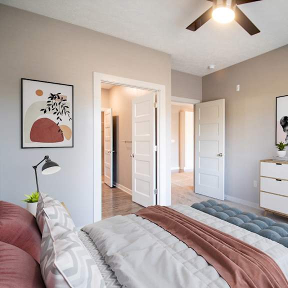 a bedroom with a bed, a chair, and a dresser.