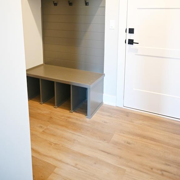 a white door is next to a shelf with several compartments.